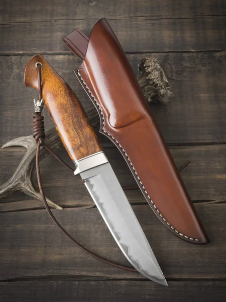 Κυνηγετικό μαχαίρι χειροποίητο σε καφέ ξύλινο φόντο — Φωτογραφία Αρχείου