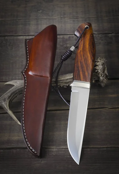 Hunting knife handmade on a brown wooden background — Stock Photo, Image