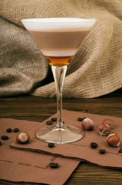 Kahve Latte. Çuval bezi ahşap bir zemin üzerine uzun bir bardak krem şanti tepesi ile kahve