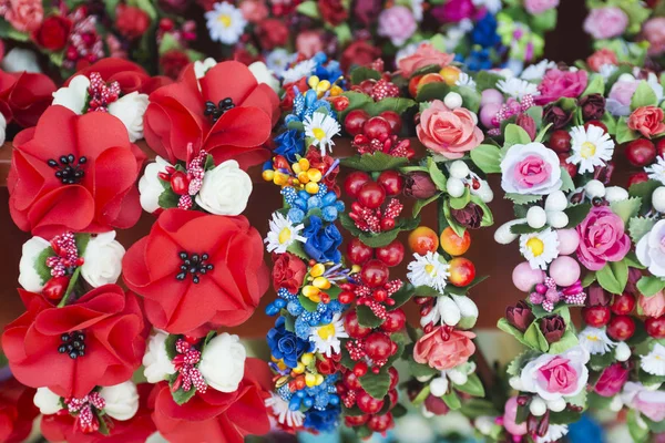 Ukrainian ethnic national handmade accessories. Woman hair accessory with red poppies, roses flowers. Selective focus