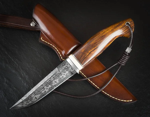 Hunting knife from Damascus mosaic with mammoth tusk on a black background. Leather Sheath Handmade — Stock Photo, Image