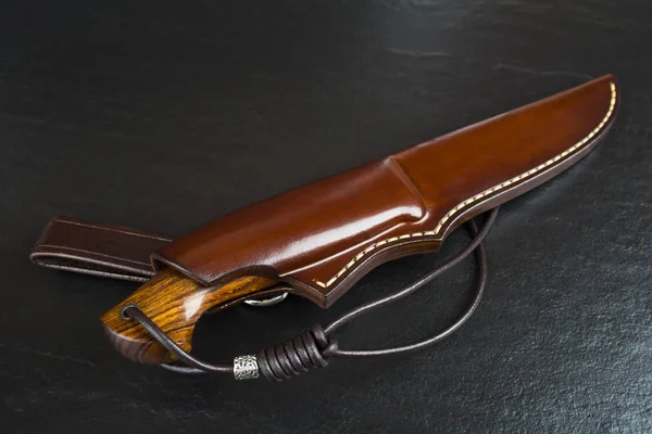黒の背景に巨大な牙とダマスカス モザイクから狩猟用ナイフ。手作りの革製の鞘 — ストック写真