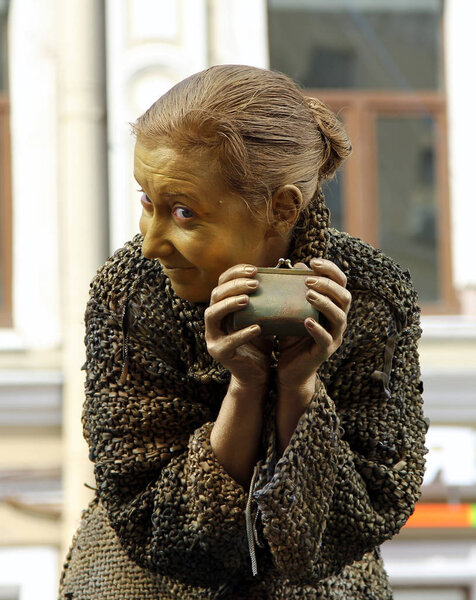 St. PETERSBURG, RUSSIA - JUL 5, 2014: Street actress (living statue) in the image of a greedy old woman from famous novel by Fyodor Dostoevsky, "Crime and Punishment"
