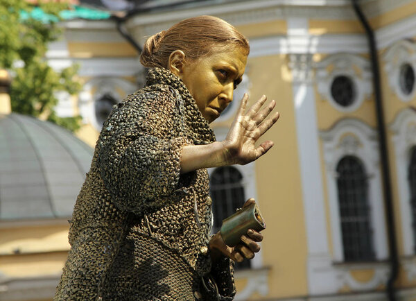 St. PETERSBURG, RUSSIA - JUL 5, 2014: Street actress (living statue) in the image of a greedy old woman from famous novel by Fyodor Dostoevsky, "Crime and Punishment"