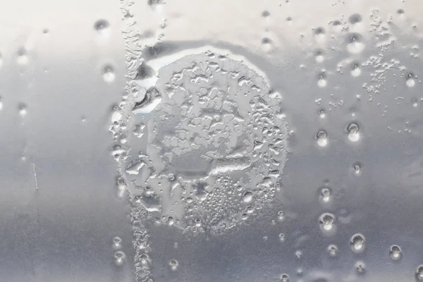 Frozen circle on the window glass