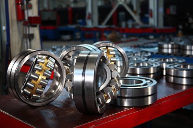 Production of bearings at the factory. Chrome plated surface. Industrial theme. Photos at the factory clipart