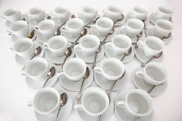 White dishes: cups and saucers for tea or coffee on a white background. View from above. Isolated object. A lot of dishes on a white background. A concept of still life. — Stock Photo, Image