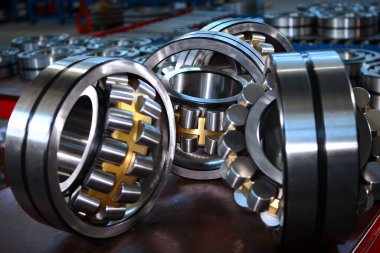 A large number of ready-made bearings in the factory. Concept of heavy industrial industry.Macro photo of the finished product. clipart