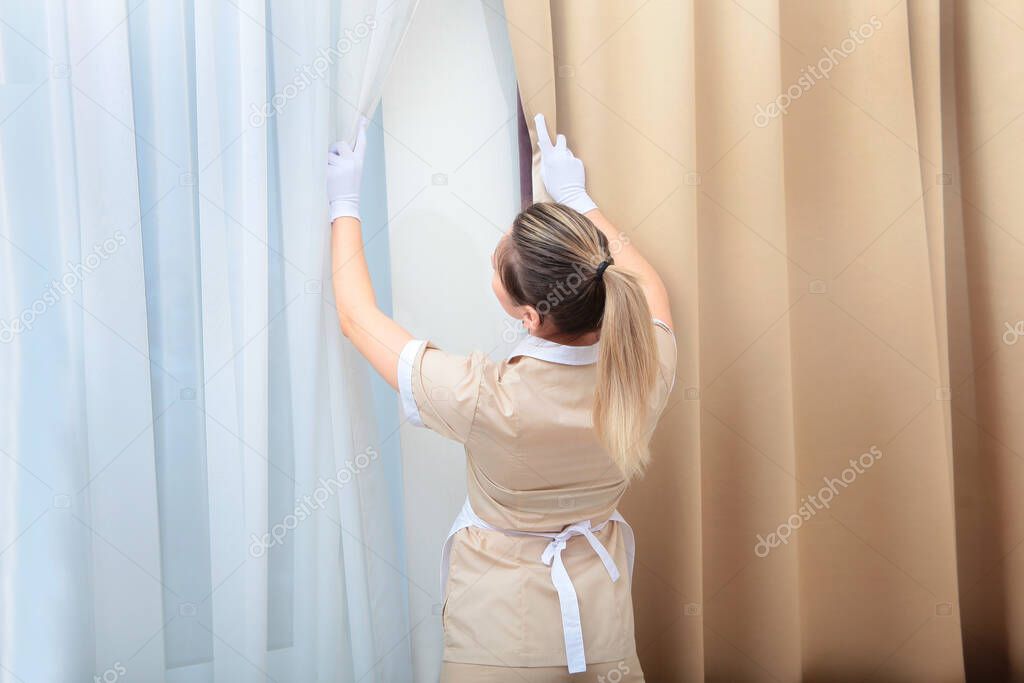 Ventilation and room cleaning. The maid in the hotel room. Copy space.