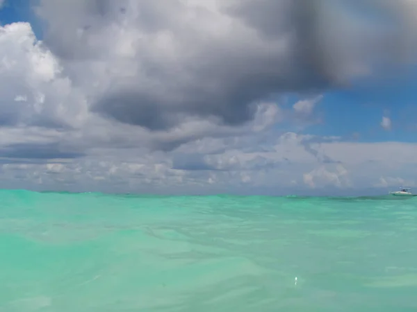 blurred underwater view of the sea surface with the sky on the horizon