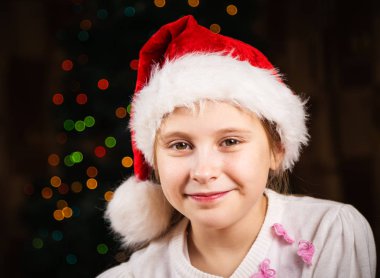 Festival arka plan üzerinde Noel şapkalı güzel kız