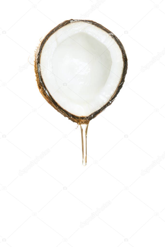 Half of a coconut with a flowing transparent liquid