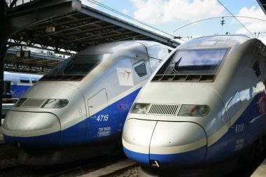 Two locomotive engines of TGV high-speed trains stationed at the Paris-Est  railway station. Paris, France.  clipart