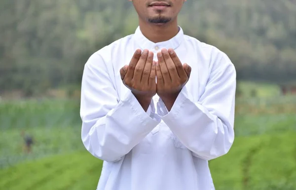 Religious muslim man praying. Islamic concept background