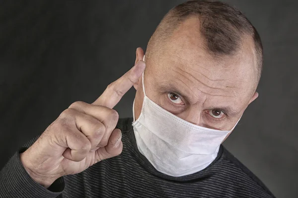 Man in a black T-shirt and a medical mask — Stock Photo, Image