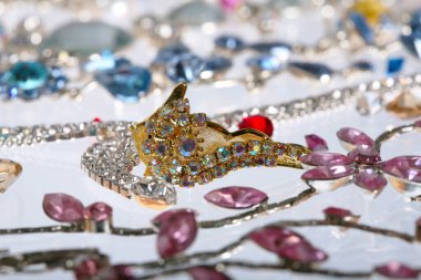 Makro zarif çeşitli mücevherler, kolyeler ve küpeler. Beyaz arka plan stüdyosunda renkli taşlar.