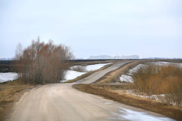 landscape season of bad roads, slush and snow melt in early spring