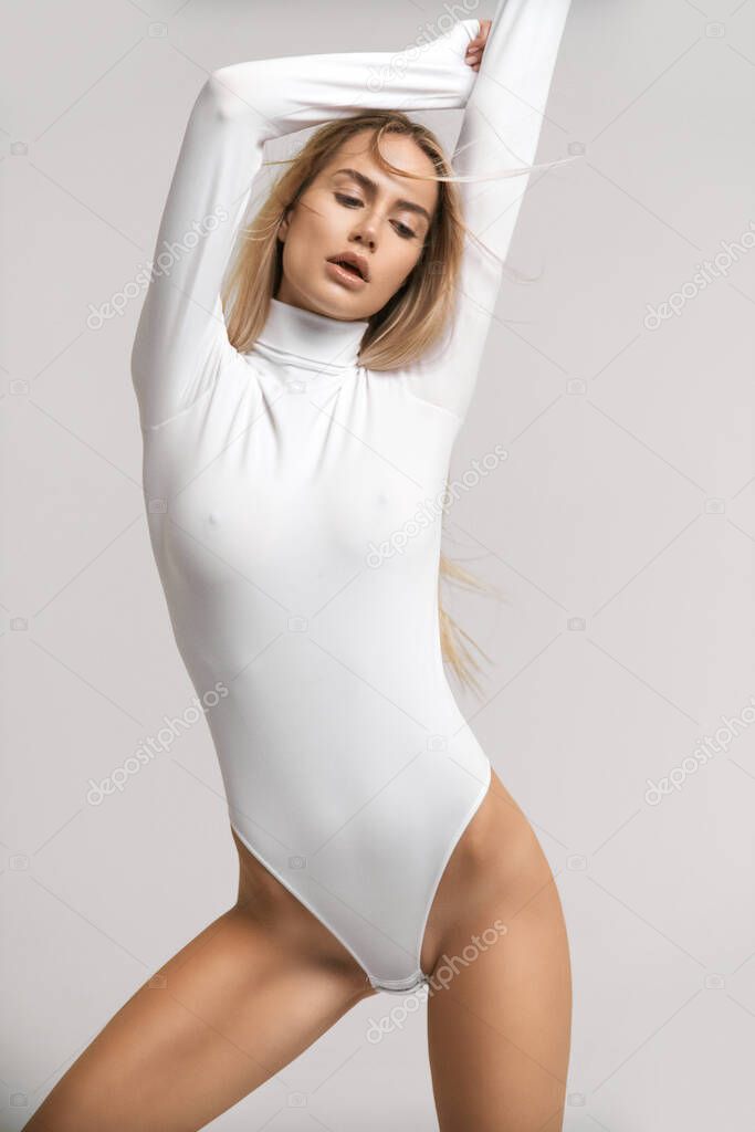 Pretty sexy girl posing in bodysuit with very fashion style good for advertise and kind of sport goods