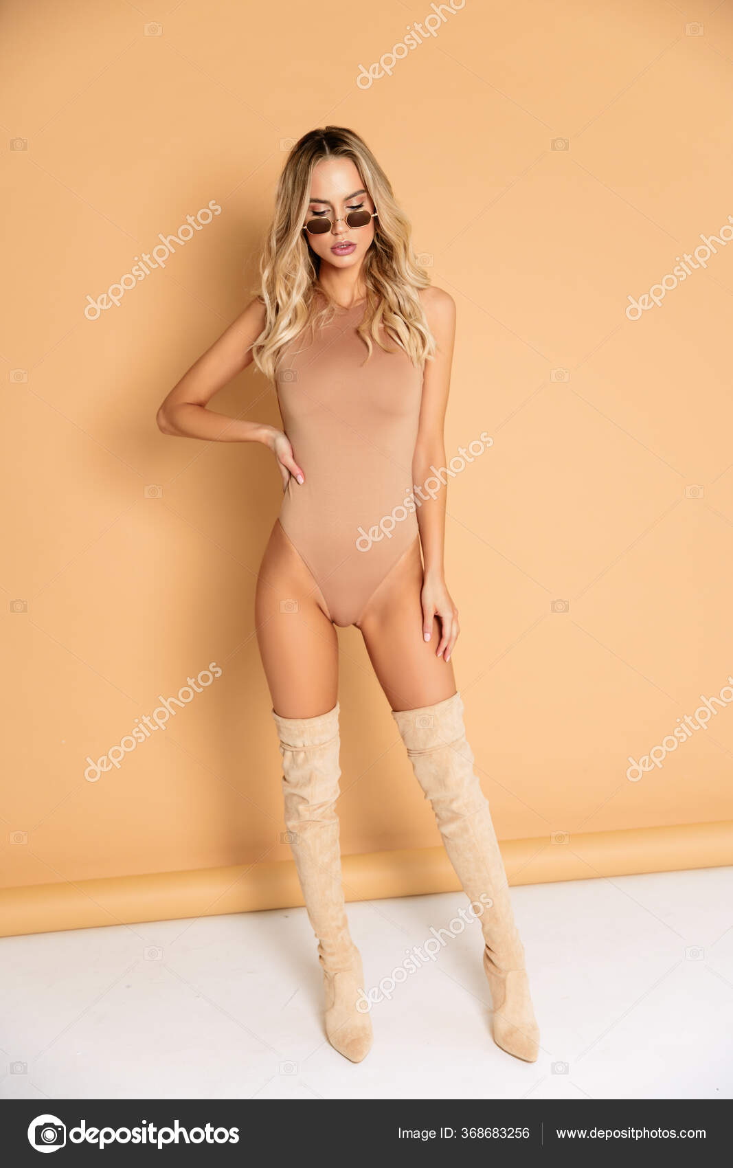 Sexy Blonde Model Perfect Skinny Body Huge Boobs Posing Beige Stock Photo  by ©evgennish 368683256