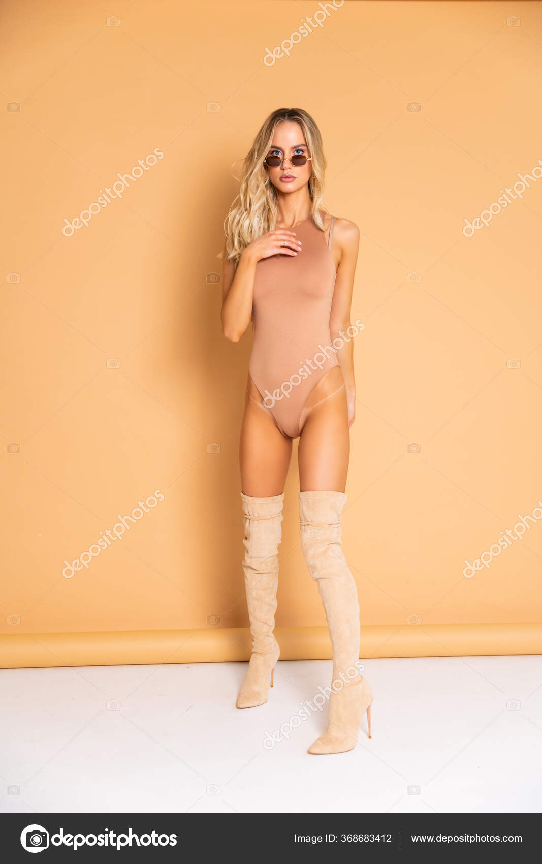 Sexy Blonde Model Perfect Skinny Body Huge Boobs Posing Beige
