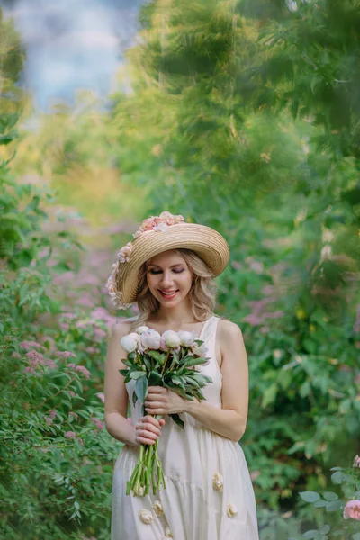 Çiçekli şapkalı ve retro elbiseli güzel bir kız bir kır evinin bahçesinde dinleniyor. Yeşil ve pembe şekerlemelerle çevrili cam bir tabakta kırmızı olgun çileklerin olduğu bir masada otururken, bir yudum su ve şakayık... 