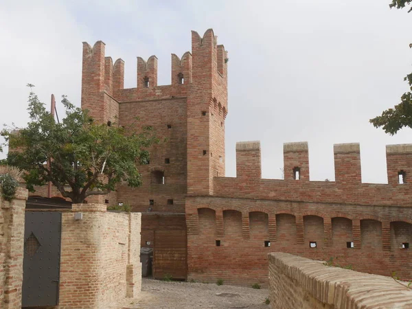 Internal walls with towers and laces around the village of Gradara with the walkway above.