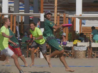 Burla Beach Cup 2019 - Athletes of Ultimate Como team ( Mixed division ) playing with the disc during a Beach Ultimate Tournament in Torre del Lago, Italy. clipart