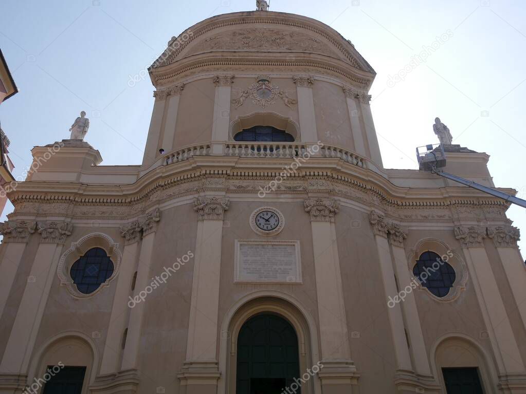 white baroque facade of collegiate basilica of San Giovanni Baptist in Imperia Oneglia