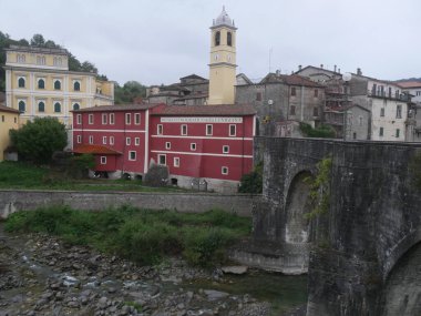 Villafranca in Lunigiana   panorama of the medieval village and of its ancient stone bridge from the Magra riverside. clipart