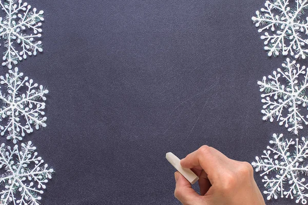 Blackboard with a hand starting to write — Stock Photo, Image