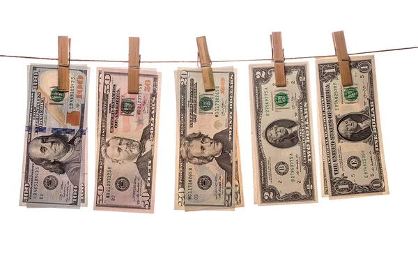 Dolarové bankovky na kolíčky na prádlo na bílém pozadí — Stock fotografie