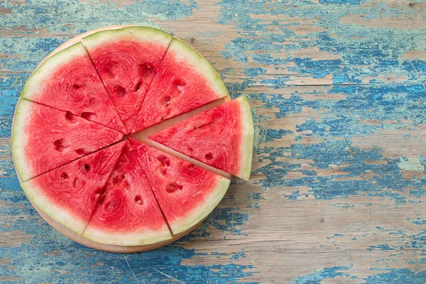 Slices of watermelon on old wooden table — Stock Photo, Image