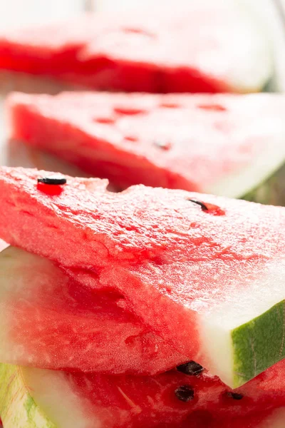 Ripe watermelon slices on a wooden table — Stock Photo, Image