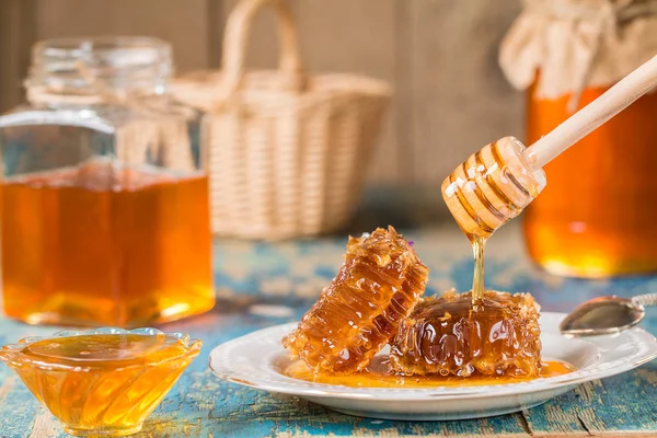 Honeycombs on plate on wooden background. — Stock Photo, Image