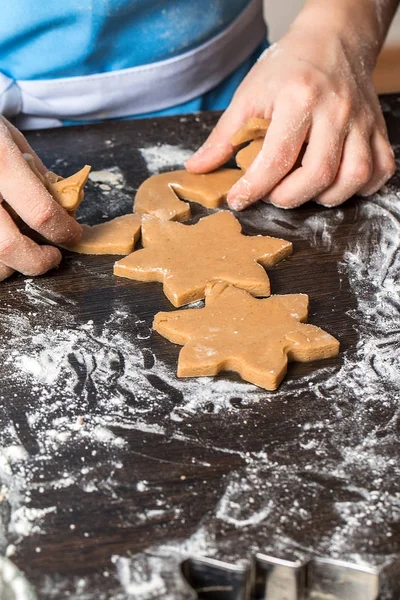 Child cutting out cookies from dough at home kitchen Stock Photo