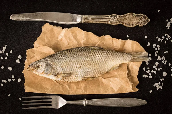 Gedroogde vis op een donkere achtergrond. Bovenaanzicht — Stockfoto