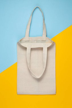 Reusable textile bag on blue background. Ecological concept.