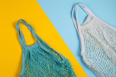 Zero waste concept. Two mesh shopping bags lie on yellow blue background