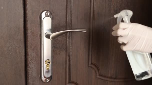 The concept of disinfecting surfaces from bacteria or viruses, cleaning the door handle with a disinfectant. — Stock Video