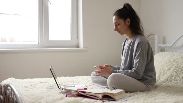 Mladá dívka se distancuje od učení pro studenty. Karanténa. Freelancer, vzdálená práce, práce doma, online vzdělávání — Stock video