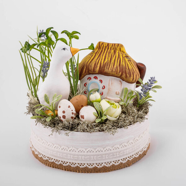 Handmade Easter composition - duck eggs flowers greens home prepared for Easter, porcelain clay material, on a white background