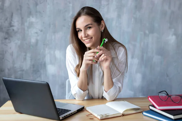 freelance blogger businesswoman girl student working with a laptop notebook on the table, online learning education shopping training, work at home, remote work, on a gray background, copy space