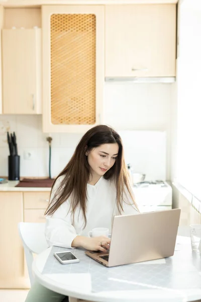 Businesswoman remote working with laptop at home. Remote working concept. The young girl freelancer copywrite from home. Talented manager remote working in laptop writing e-mail