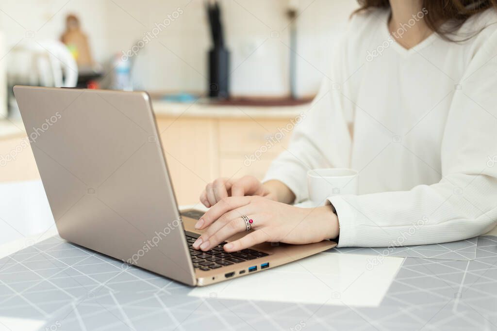 The girl distance working with laptop at home. Talented manager remote working in laptop writing e-mail. Close up girl hands writing on laptop
