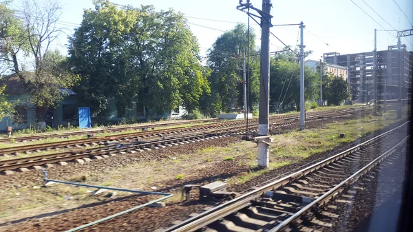 Rails from the train window in motion - trip in Ukraine — Stock Photo, Image