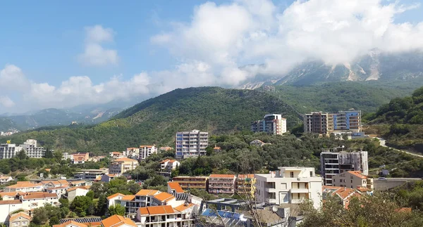 green landscape with houses under blue sky near Becici - resort of Montenegro