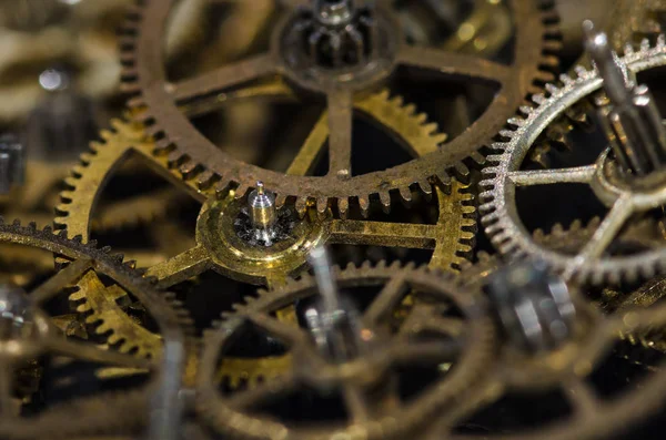Watch Parts: Collection of Vintage Metallic Watch Gears on a Black Surface