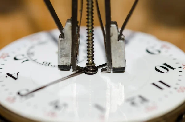 Watch Repair: Hands Remover About to Lift The Hands from a Pocket Watch Movement
