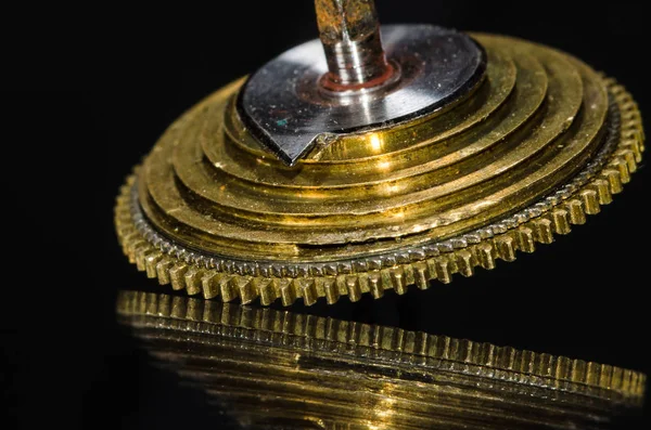 Watch Repair: Vintage Pocket Watch Fusee Cone Resting on a Black Surface