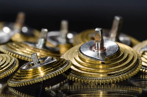 Watch Repair: Vintage Pocket Watch Fusee Cones Resting on a Black Surface